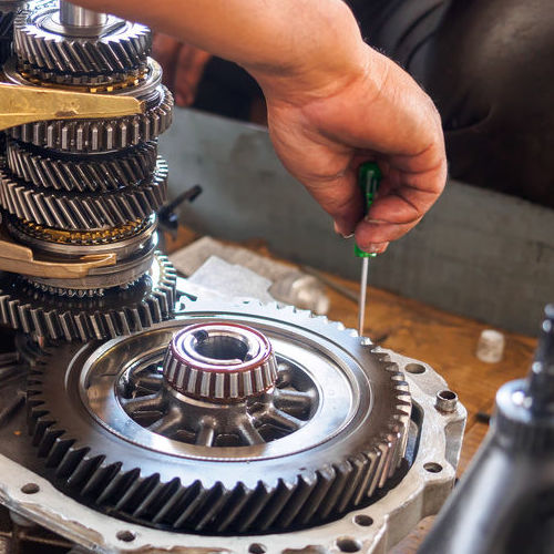 A Technician Works on a Gearbox.