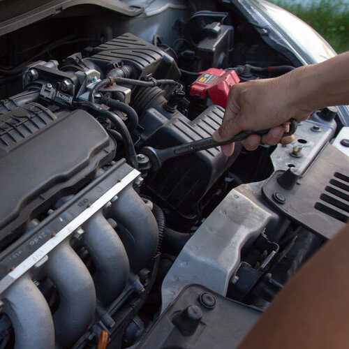 Close-up of car engine being worked on.