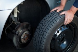 Mechanic Holding Tire