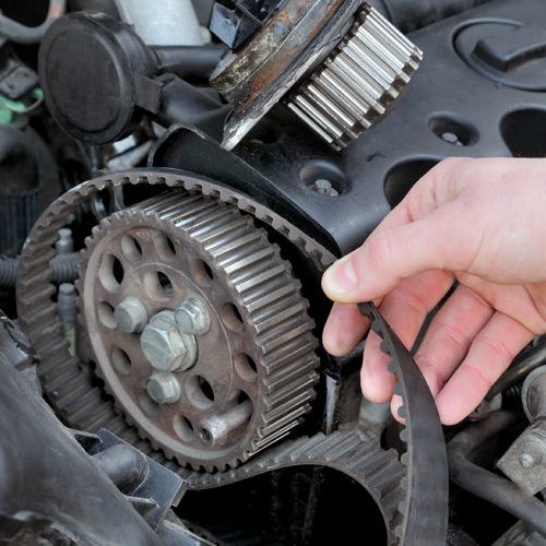 A Picture of a Mechanic Replacing a Timing Belt.